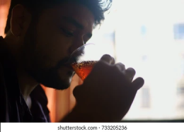 young-indian-guy-seen-drinking-260nw-733205236